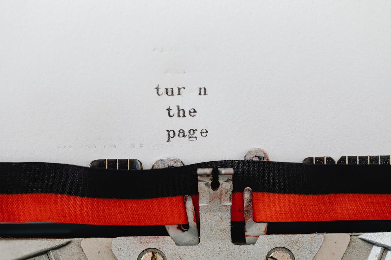Close-up of a vintage typewriter with text turn the page typed on paper, symbolizing change and new beginnings.